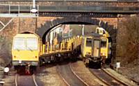 A long welded rail delivery train waits at Castleton Station circa 1990.  H Muncaster (on duty)
